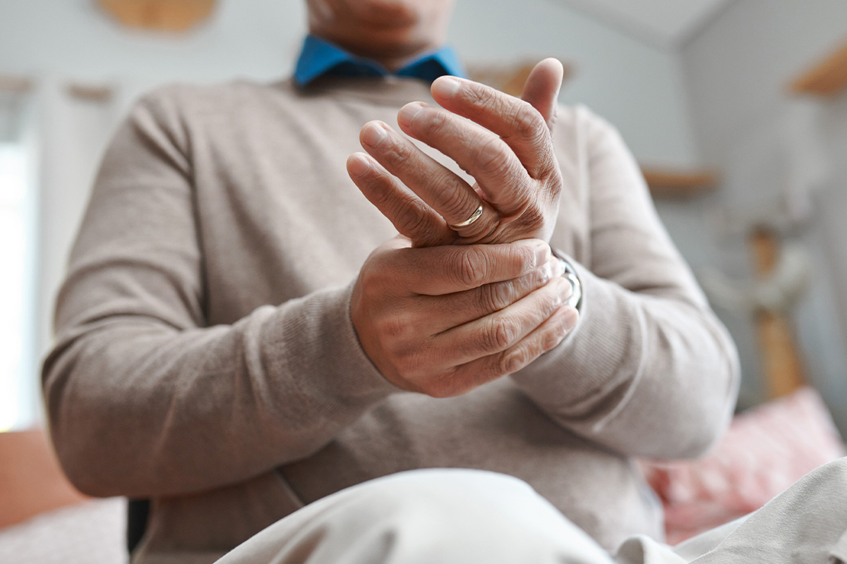 Person holding their wrist in discomfort, showing arthritis and joint pain treated with PRP injections in Parsippany-Troy Hills.