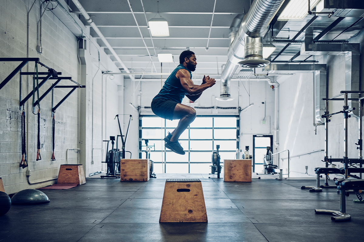 Man lifting a barbell during rehabilitation after spinal stenosis treatment in Parsippany-Troy Hills.