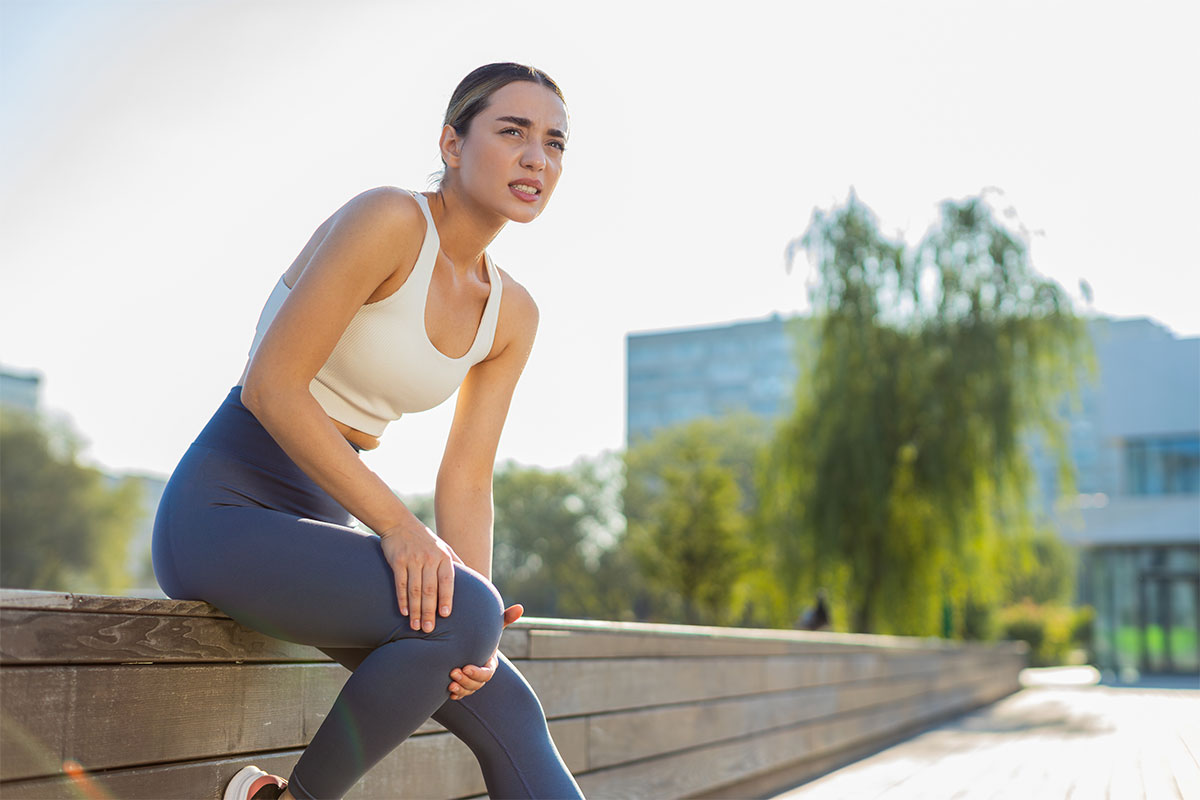Woman experiencing leg pain before receiving endoscopic discectomy in Parsippany-Troy Hills for nerve relief.
