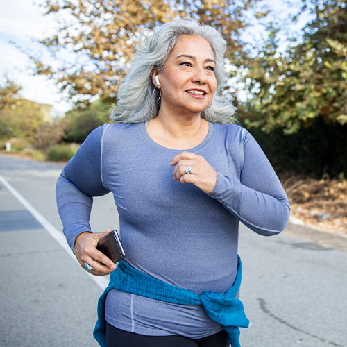 Older woman jogging comfortably after treatment with a back specialist Parsippany-Troy Hills